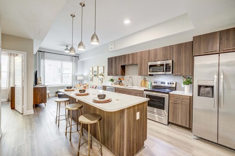 Long kitchen island with stainless appliances